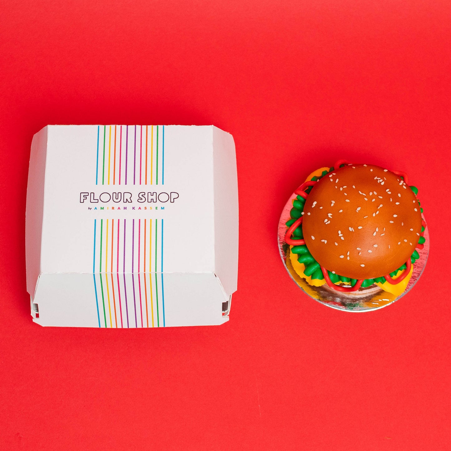 Small and large vanilla cake that is decorated to look like a cheese burger