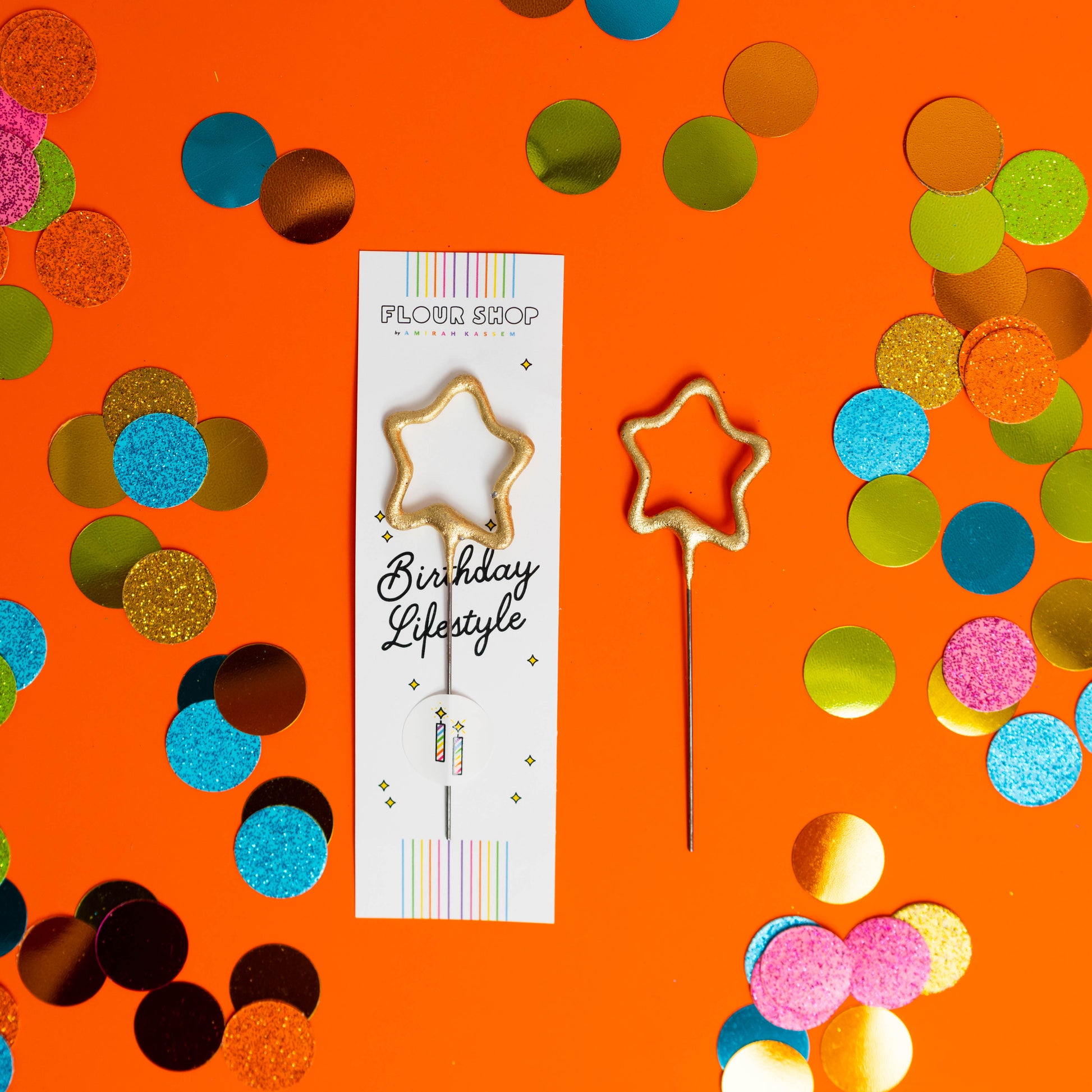 Individual mini gold star sparkler candle in FLOUR SHOP packaging