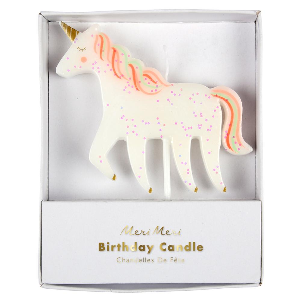 Glittering unicorn candle with colorful mane and tail and shiny gold foil