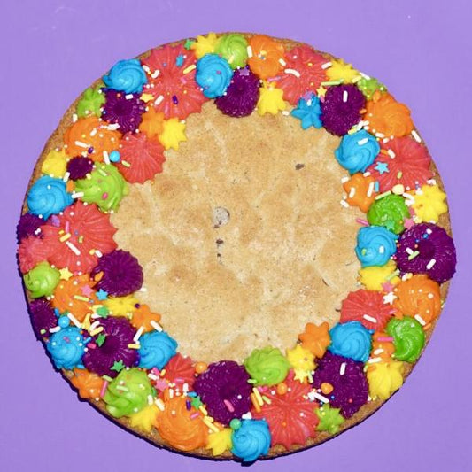 Cookie cake decorated with rainbow border and sprinkles