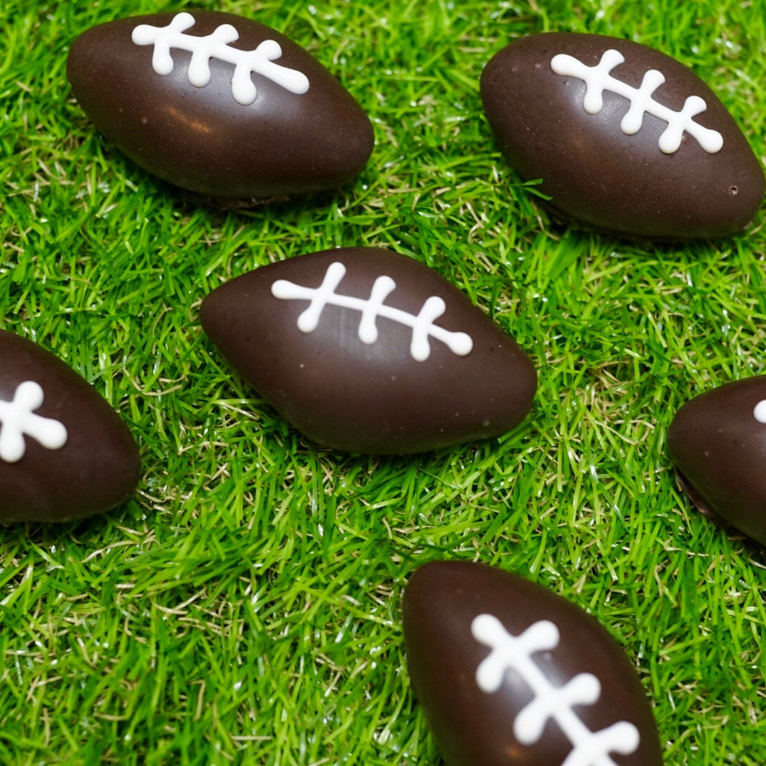  24-Pack of our Chocolate Chip Cake Balls, shaped and decorated like footballs