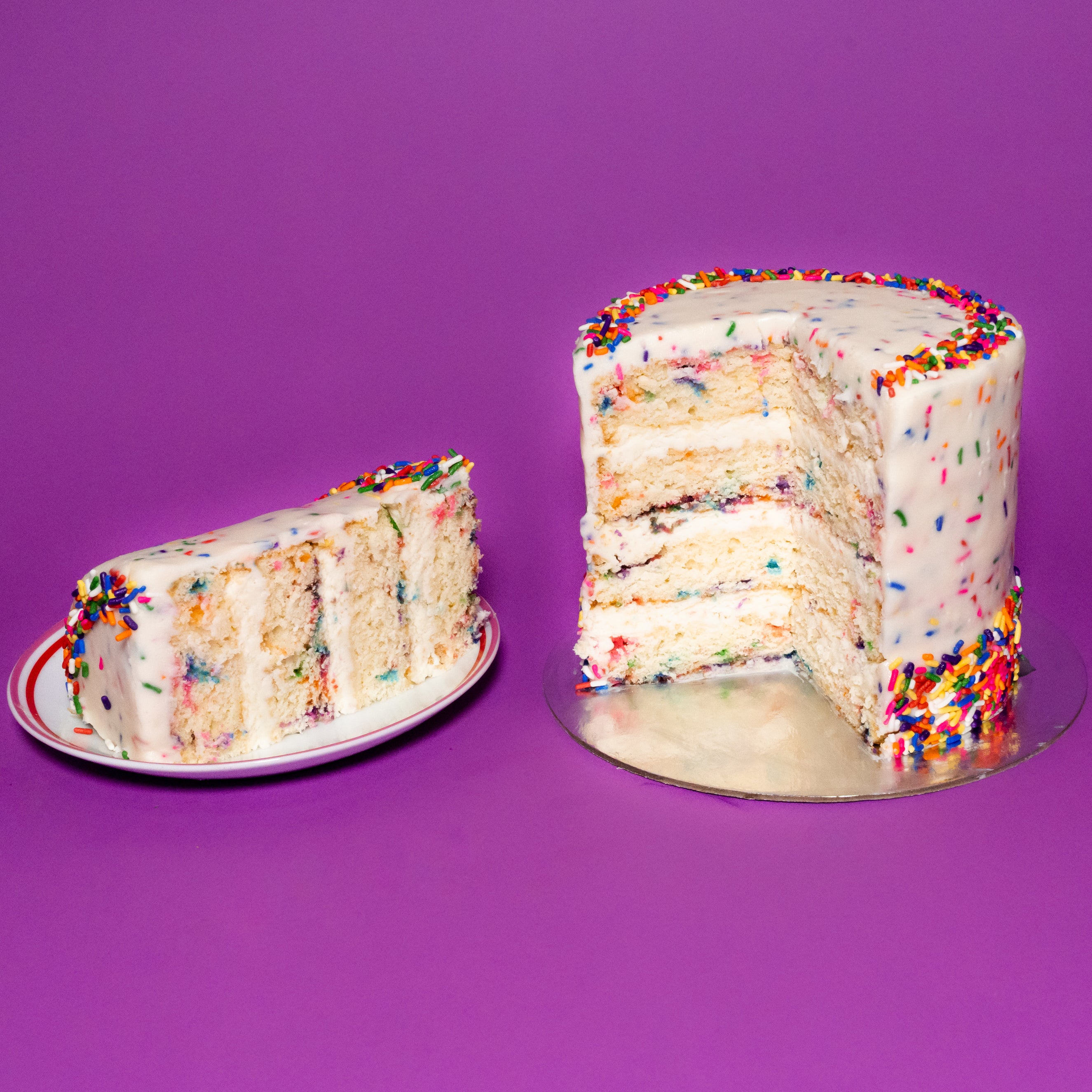 Purple drip cake with sprinkles and mini choco bars - FunCakes